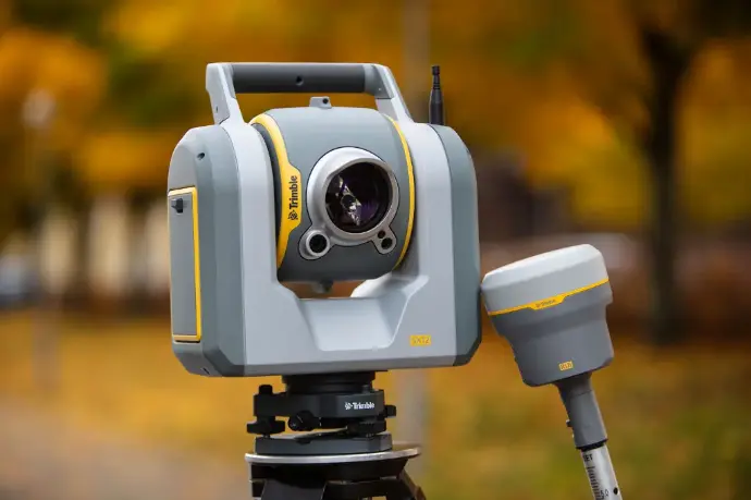 Trimble SX12 scannende total station naast een Trimble R12i GNSS‑ontvanger